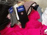 a pile of clothing that is sitting on a bed
