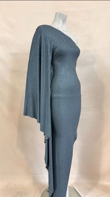 the dress is grey and has a long cape on the shoulders
