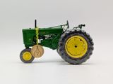 a toy tractor that is sitting on a white surface