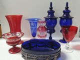 many different colored glass vases on a table