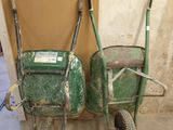two wheelbarrows that are sitting next to each other