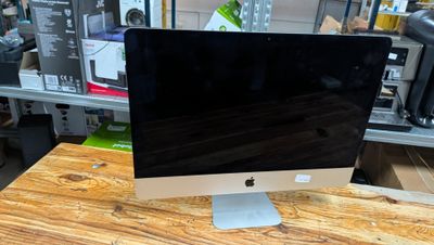 a computer monitor sitting on top of a wooden desk