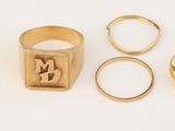 trois bagues en or, une bague et une bague sur laquelle est gravée la photo d'un homme