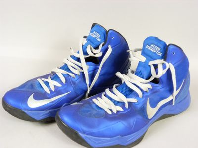 blue and white basketball shoes with white laces on a white surface