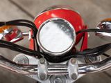a close up of a red motorcycle handlebars