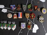 a lot of badges that are on a black table