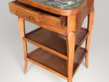 an old wooden table with a marble top and two shelves