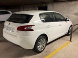 a white car parked in a parking garage next to a parking meter