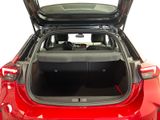 the back of a red car with its trunk open showing the trunk space