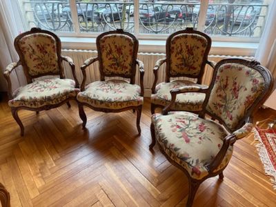 four chairs that are sitting in front of a window
