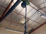 a green light hanging from the ceiling of a building