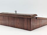 a wooden box with a key on top of it