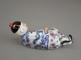 a figurine of a man laying down on the ground