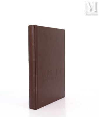 an old book with a brown cover sitting on top of a white surface