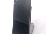 a cell phone that is sitting on top of a stand