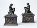 pair of antique bronze figurines of a woman and a man