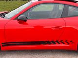a red sports car parked on the side of the road