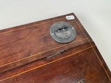a small wooden box with a metal lid on a table
