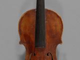 an old violin with a bow on a gray background