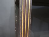 a close up of a wooden table with a black and gold design