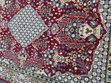 a red rug on the ground next to a pair of shoes