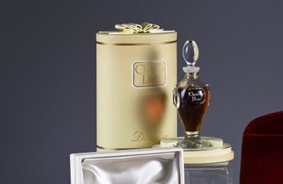 a bottle of perfume sitting on a table next to a box