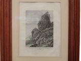 a framed picture of a mountain scene with rocks in the foreground