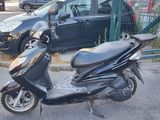 a scooter that is parked on the side of the street