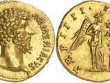 a gold coin with an image of a man holding a sword