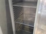 an open refrigerator that is sitting inside of a building