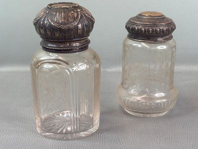two salt and pepper shakers sitting on a table