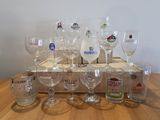bottles and glasses are sitting on a wooden tray on a table