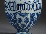a blue and white vase with a sign on it