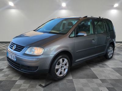 the grey van is parked on a checkered floor in the garage