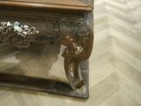 a wooden table with a glass top on a wooden floor