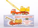 a toy truck and crane sitting on top of a box