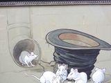 painting of a group of mice climbing out of a hole in a wall