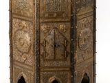 an ornately carved wooden table with a door on the top