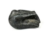 a black stone sculpture of a hand on a white surface
