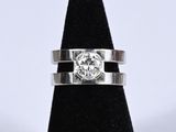 a close up of a ring with a diamond on top of it