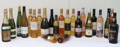 many bottles of wine that are lined up on the table
