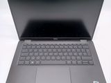 a laptop with a keyboard on it sitting on a table