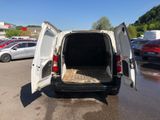 a white van with its door open in a parking lot