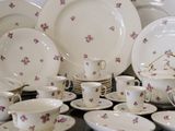 many plates and cups and saucers on a table
