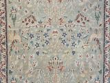 a blue and red rug with a floral design on it