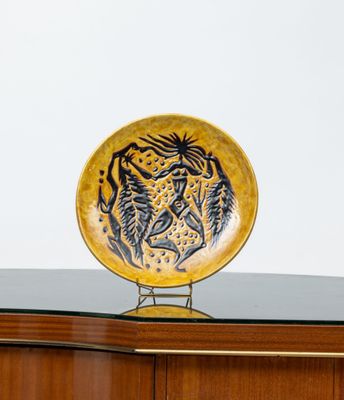 a yellow plate with a tiger on it sitting on a table
