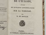 an open book with a black and white image of a map on it