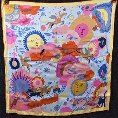 a colorful scarf hanging on a clothes rack on the wall