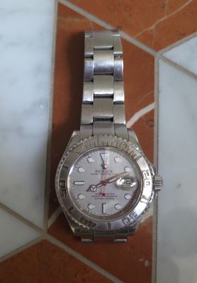 a watch that is sitting on a tile floor