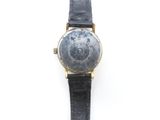 an image of a close up of a wrist watch on a white surface